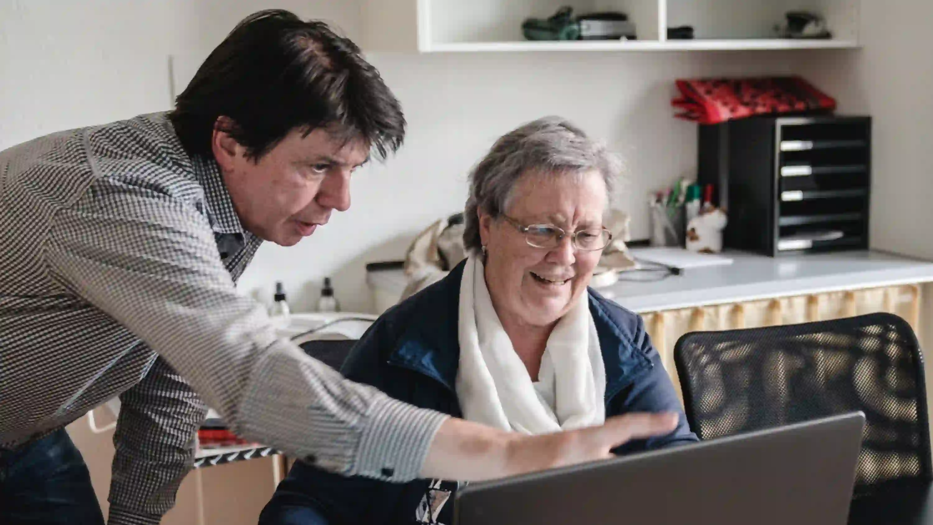 Kursleiter zeigt auf Laptop